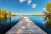 landscape photograph of a dock stretching out into a lake