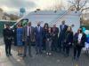 group of people posing in front of a National Grid truck