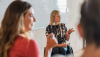 Women meeting with white board in background