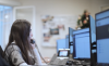 Woman on the phone at the computer