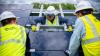 Duke Energy employees installing solar panels
