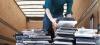 man loading a trailer with recycled laptops