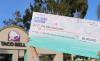 A large check in front of a Taco Bell reads " Pay to the order of : Live Más Scholarships"